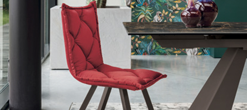 Red fabric chair with black legs.