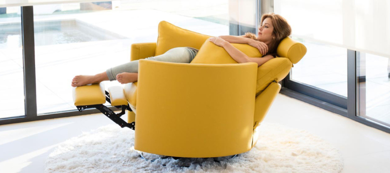 Girl relaxing on yellow fabric leather armchair sofa.