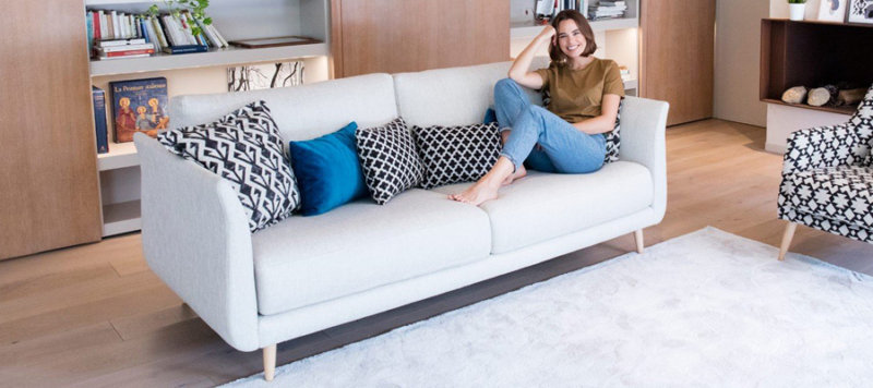 Girl relaxing on a comfy 3-seater sofa bought by Andreotti Furniture.