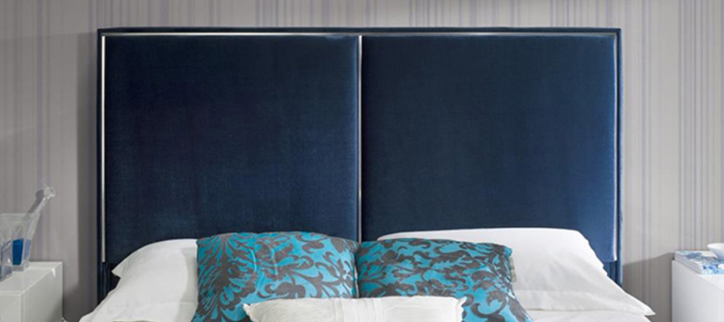 Close up blue velvet material of bed.