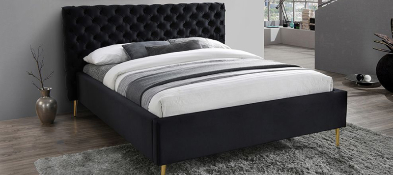 Eros bed in bedroom fabric velvet black and gold legs in a big bedroom space..