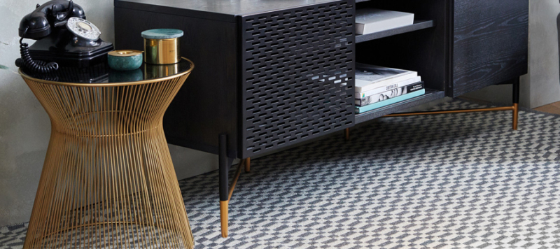 Side table next to a black console.