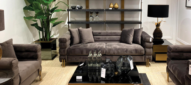 Grey velvet elegant sofa in a luxury living room..